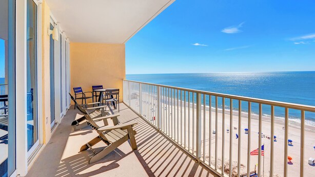 A balcony with a view of the beach, outdoor seating, and a railing. - San Carlos 1108 by Liquid Life (Gulf Shores)