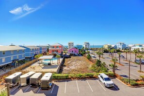 A coastal hotel with multiple buildings, a parking lot, and a pool area. - Sanibel 307 by Liquid Life (Gulf Shores)