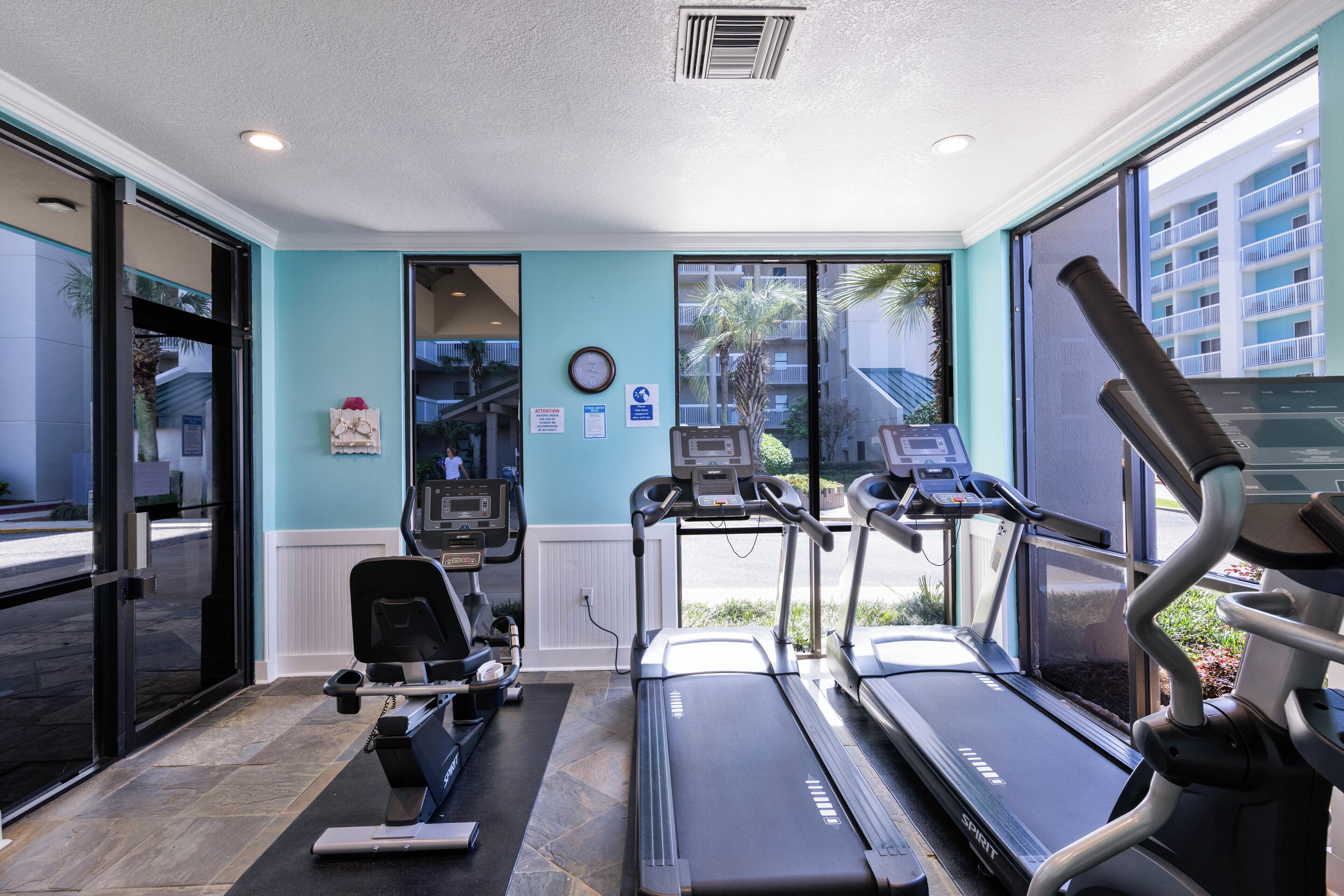 A gym with treadmills, an elliptical, and a stationary bike.