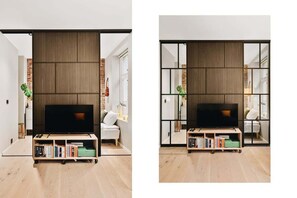 Relax in this stylish living room with a large flat-screen TV, bookshelf, and comfortable seating area.
