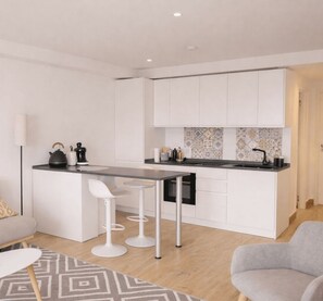Een moderne keuken met witte kasten, een centraal eiland met krukken, en een decoratieve spatwand.
