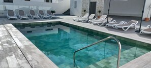 A rectangular pool with a tiled edge and a metal ladder. - La Familia Mijas Holiday Apartments (Mijas)