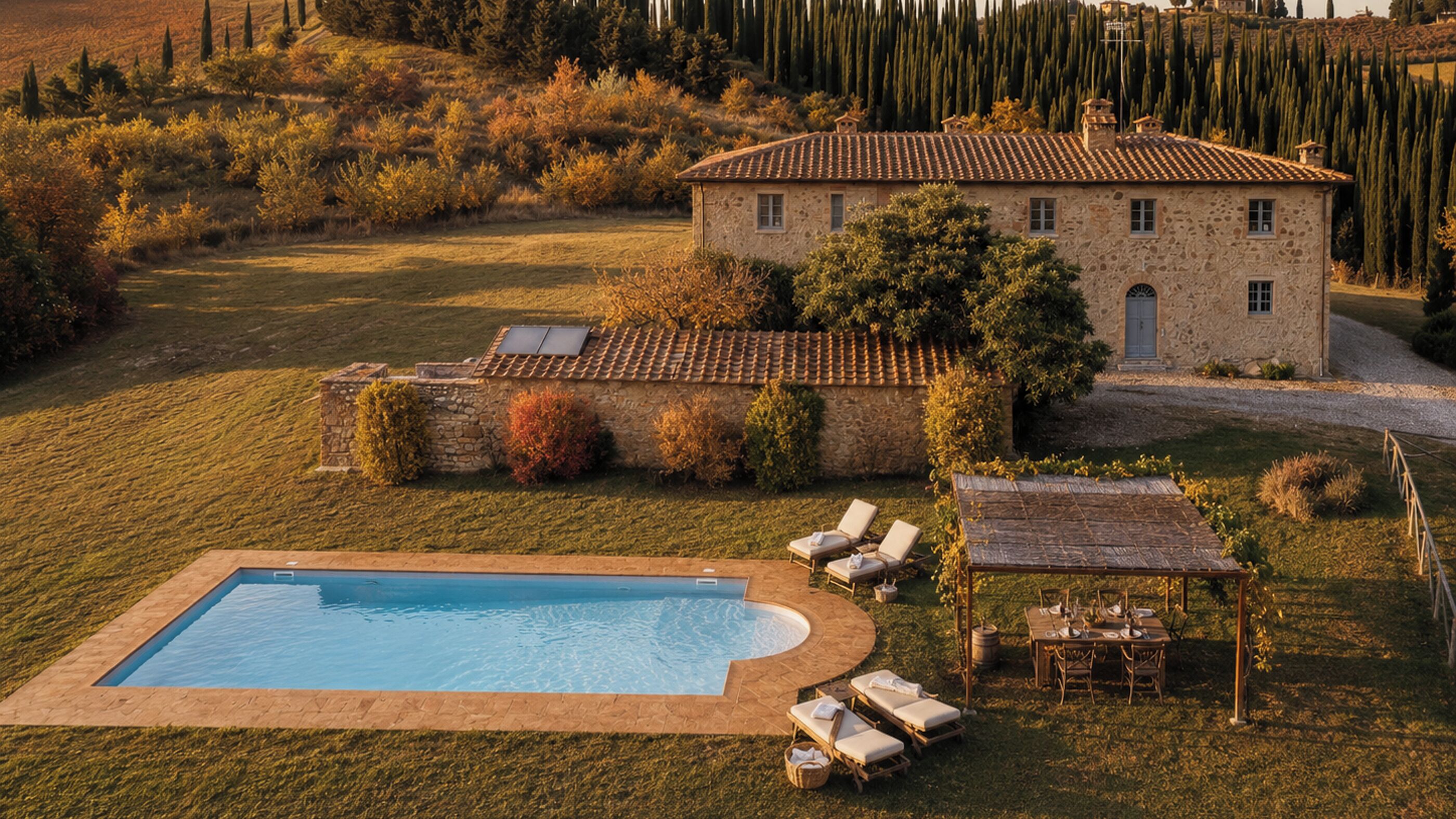 A stone villa with a swimming pool, outdoor seating, and a garden.
