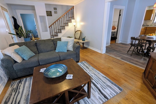 Living room with queen pull-out couch bed, fitted with 2" memory foam topper.