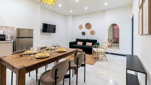 A modern living space with a dining area, kitchen, and seating area. - Argote 2 - One Bedroom Apartment, Sleeps 4 (Sevilla)