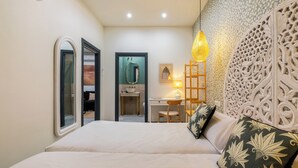 A bedroom with a bed, a desk, and a chair. There is a mirror, a lamp, and a decorative wall panel. - Argote 5 - One Bedroom Apartment, Sleeps 4 (Sevilla)