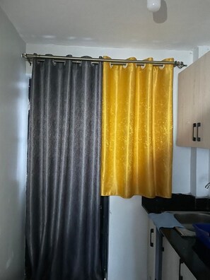 Bathroom features a shower curtain, sink, and mirror.