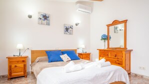 A bedroom with a wooden bed, two nightstands with lamps, a dresser, and a mirror. - Ca Na Xisca Pollen a (Pollenca)