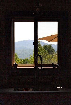 A window with a view of mountains and trees, a faucet, and a towel rack. - Private, Mountain views, Close to Horse Show Grounds, Lake Placid and Hiking (Keene)