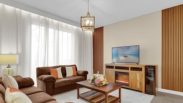 A modern living room with a sofa, coffee table, and TV.