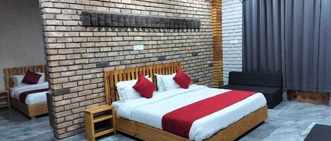 A modern bedroom with a brick wall, a wooden bed, a small bedside table, and a grey curtain.