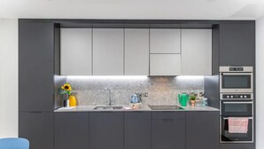 A modern kitchen with a built-in oven, a sink, and a countertop. - The Residence Dublin (Dublin)