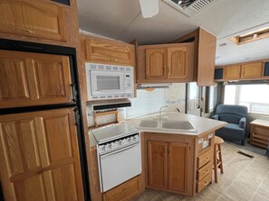 Fridge, microwave, stovetop, cookware/dishes/utensils