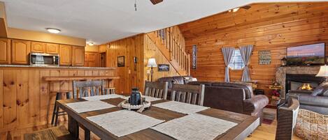 Un intérieur en bois comprenant une salle à manger, une cuisine et un espace de vie.