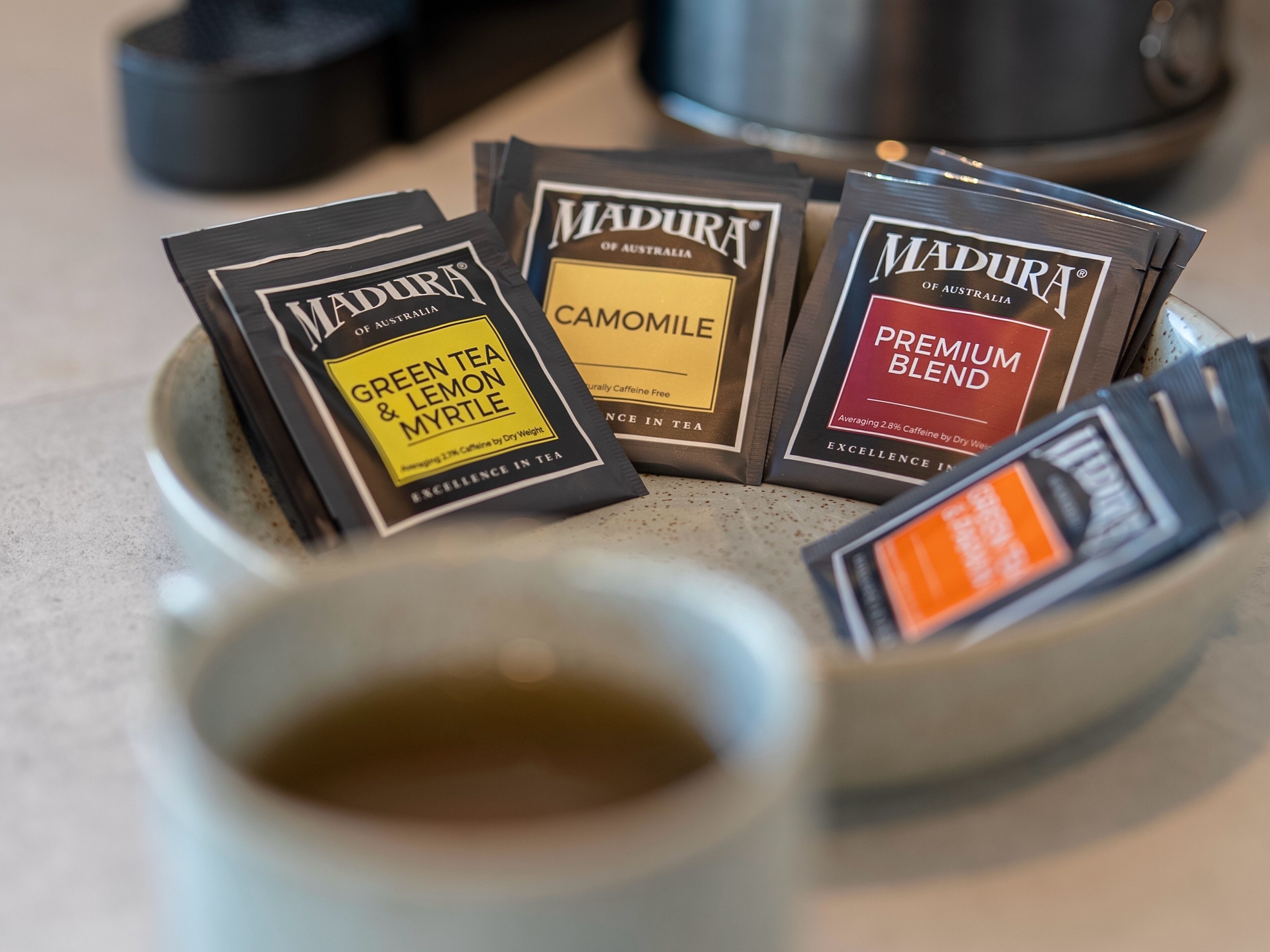 A collection of tea bags in a ceramic cup.