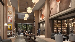 A spacious lobby with a central seating area, a coffee table, and a bookshelf filled with books. - InterContinental Real Lima Miraflores by IHG (Lima)