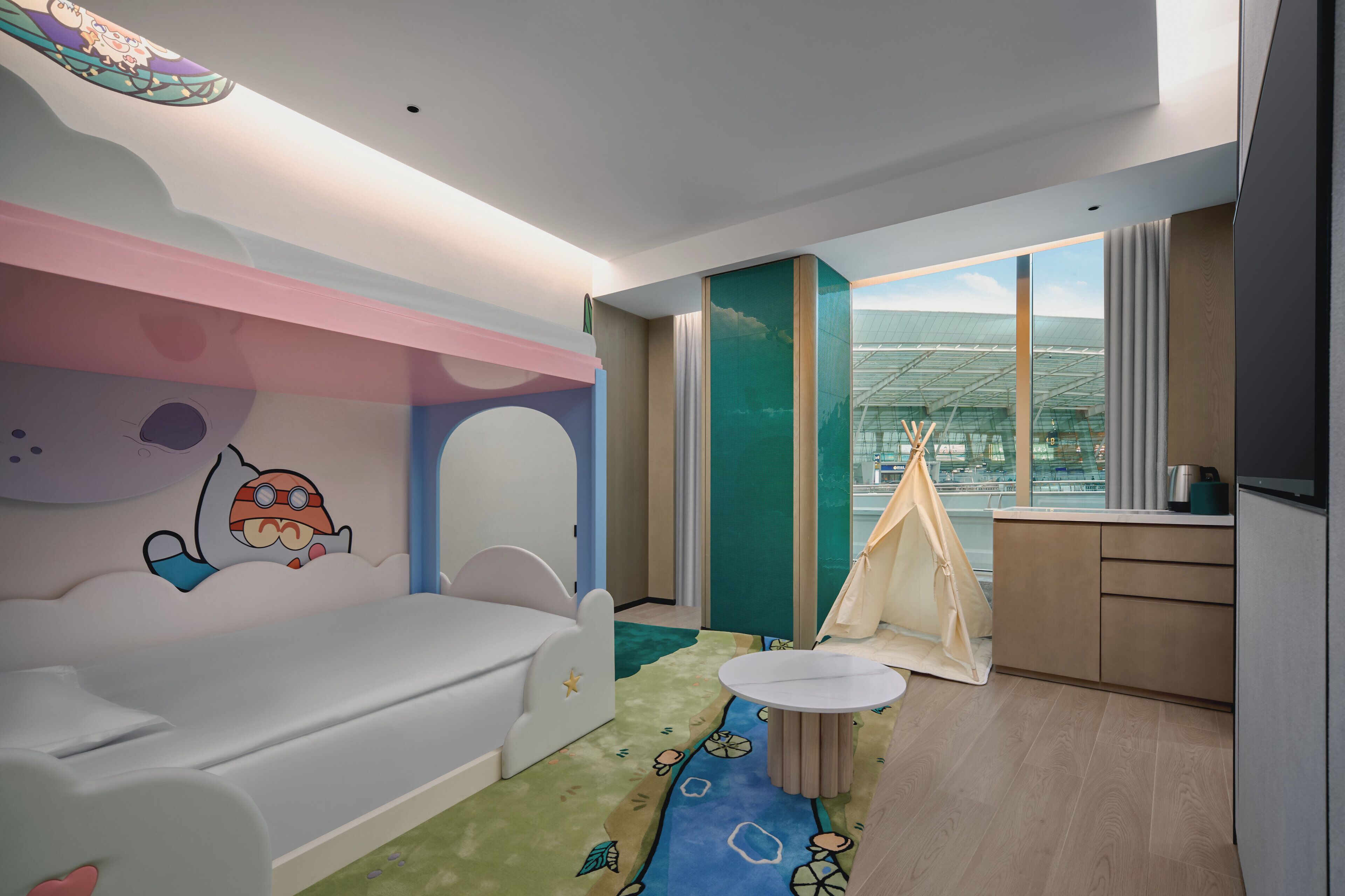 A children's room with a bed, a play area, a small table, and a tent.