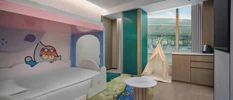 A children's room with a bed, a play area, a small table, and a tent.