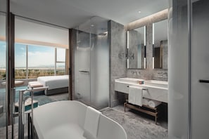 A modern bathroom with a glass-enclosed shower, a large bathtub, and a vanity with a mirror. - Holiday Inn Wuhan Tianhe Airport by IHG (Wuhan)