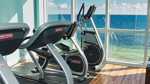 A gym with treadmills and elliptical machines, large windows with a view of the ocean. - Luxury 23rd floor  Penthouse End Unit-Panoramic Ocean Front Views-Beach Service (Panama City Beach)