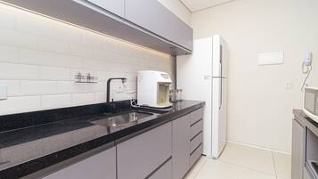 Fridge, microwave, coffee/tea maker, cookware/dishes/utensils