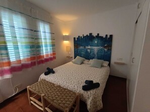 A bedroom with a bed, a bench, a night sky mural, and a window with curtains. - STUNNING SEMI-DETACHED HOME IN SOTA EL CAMPANAR (Cadaqués)