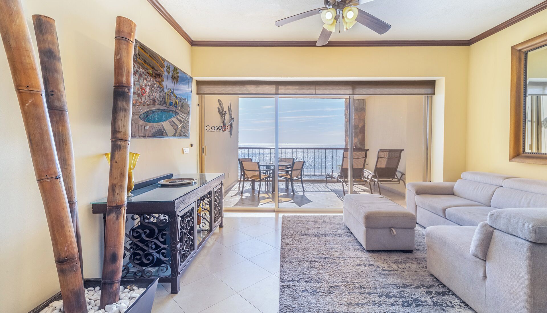 A spacious living area with a balcony overlooking a scenic view.