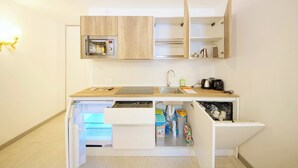 A compact kitchen with built-in appliances, a sink, and storage cabinets. - DolceVita Apartments N. 521 (Venice)