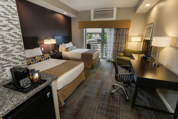 Spacious guest room with modern amenities, two comfortable beds, and a convenient workspace.