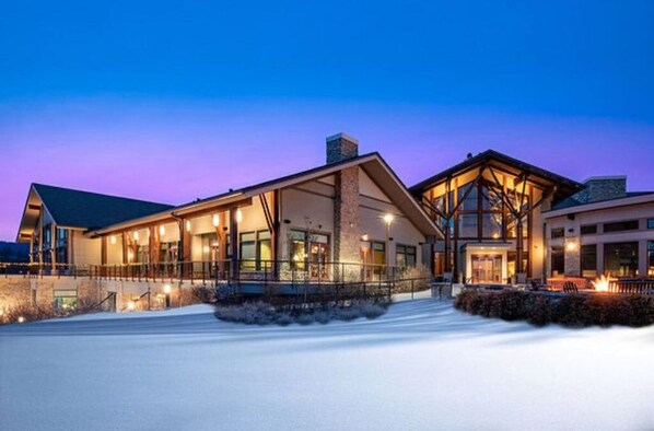 Welcome to our hotel, featuring a striking entrance with a covered porch and large windows.