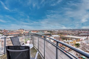 A balcony with a view of a cityscape, including buildings and a clear sky. - The Pinnacle by Cotels (Northampton)