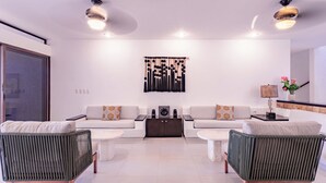 A modern living room with two sofas, a coffee table, and a side table. - VILLA BELLAMAR AKUMAL (Akumal)