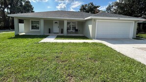 A single-story house with a front porch, a garage, and a well-maintained lawn.