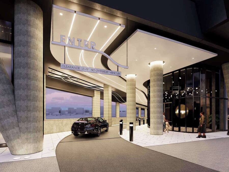 A modern building entrance with a large sign reading "ENTIRE" and a car parked outside.