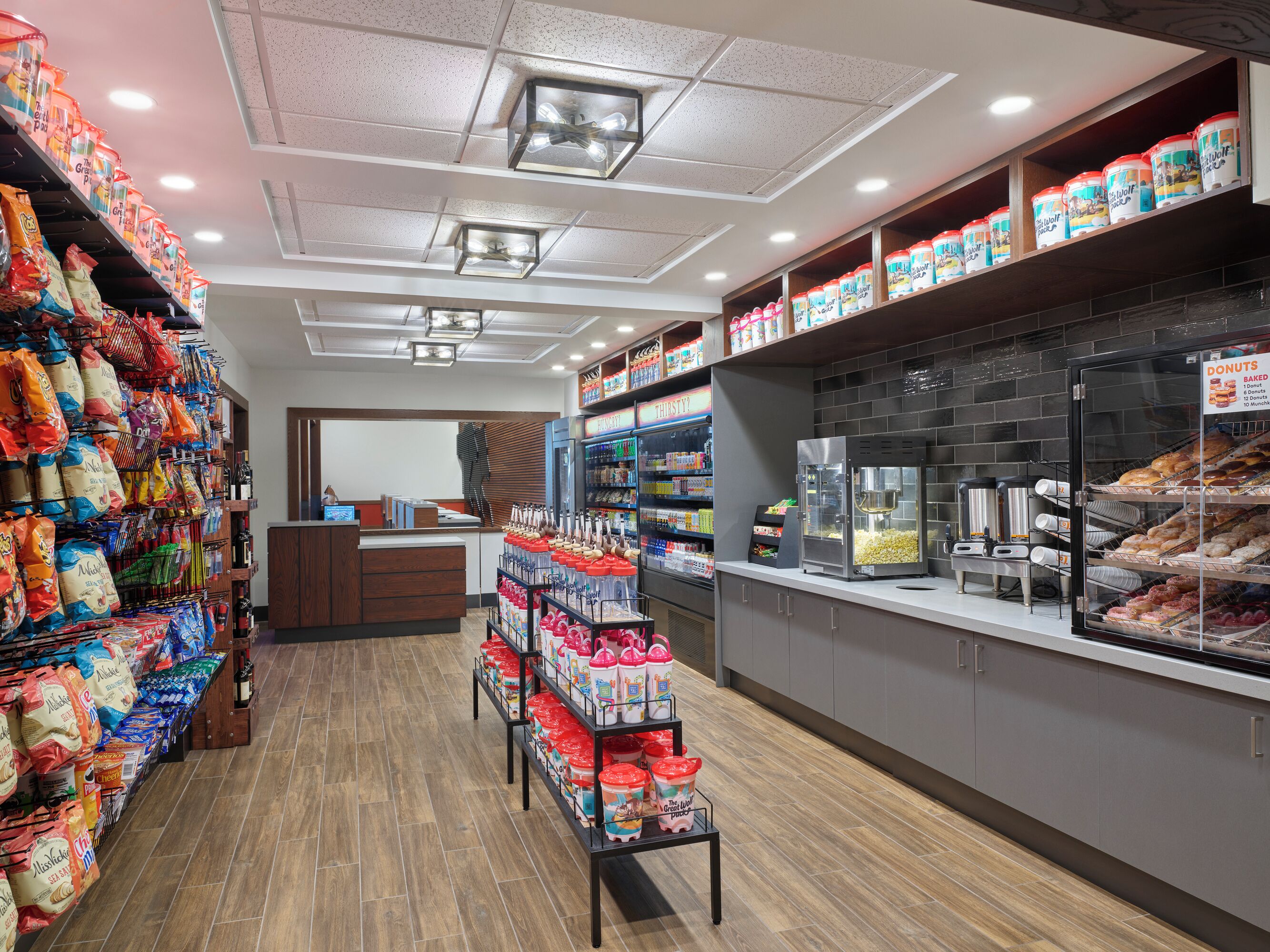 A bakery with shelves of baked goods and a popcorn machine.