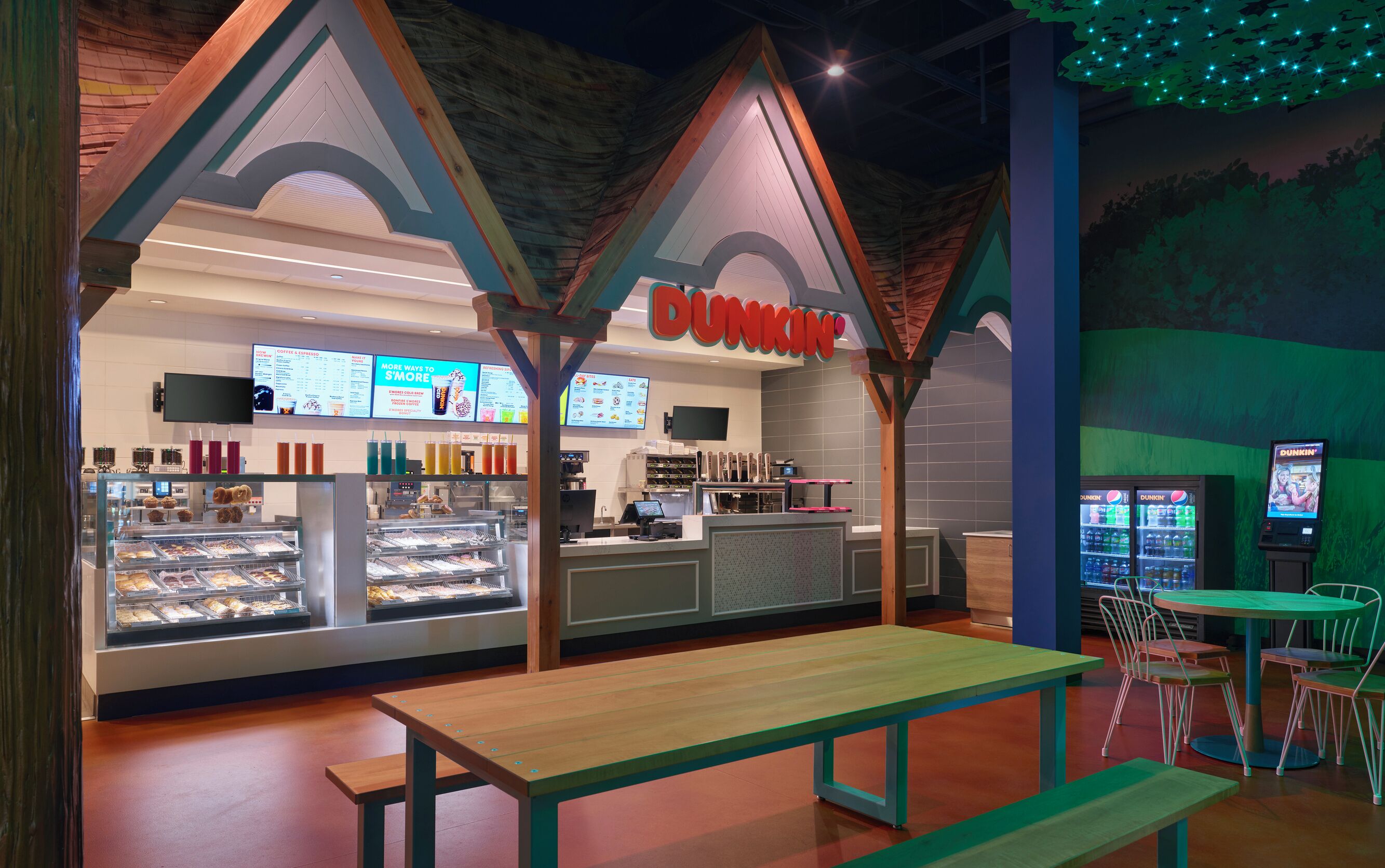 A Dunkin' Donuts with a modern interior, including a counter, display cases, and seating area.