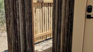 A wooden gate leading to a building with a keypad lock. - Capitol Reef Dome | Willow (Hanksville)