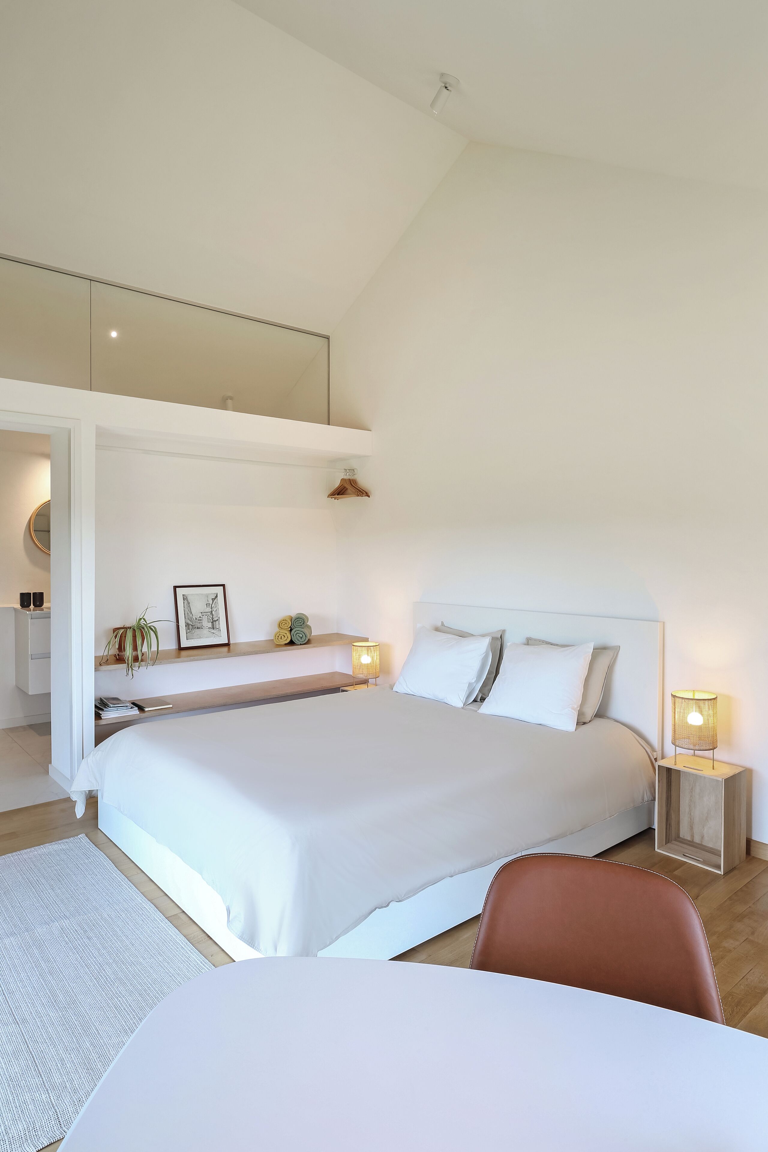 Une chambre moderne avec un grand lit, des tables de chevet, un bureau et une chaise.