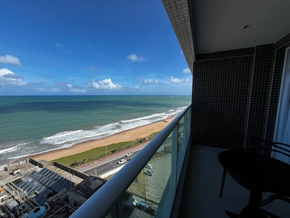 Un balcon avec vue sur la plage et l’océan.
