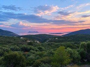 A mountainous landscape with a valley, a road, and scattered buildings. - Eleftherion Comfort Living Lefkada (Lefkada)