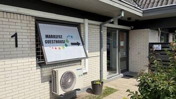 A building with a sign for 'Marielyst Guesthouse' and a number '1' on the wall.