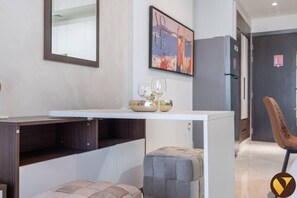 Enjoy a tranquil space with a console table, cushioned bench, and framed artwork.