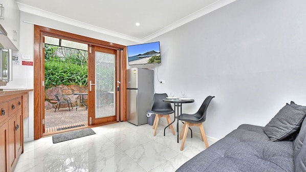 Enjoy a bright and airy space with a sliding door to an outdoor area offering views of lush greenery and a distant landscape.
