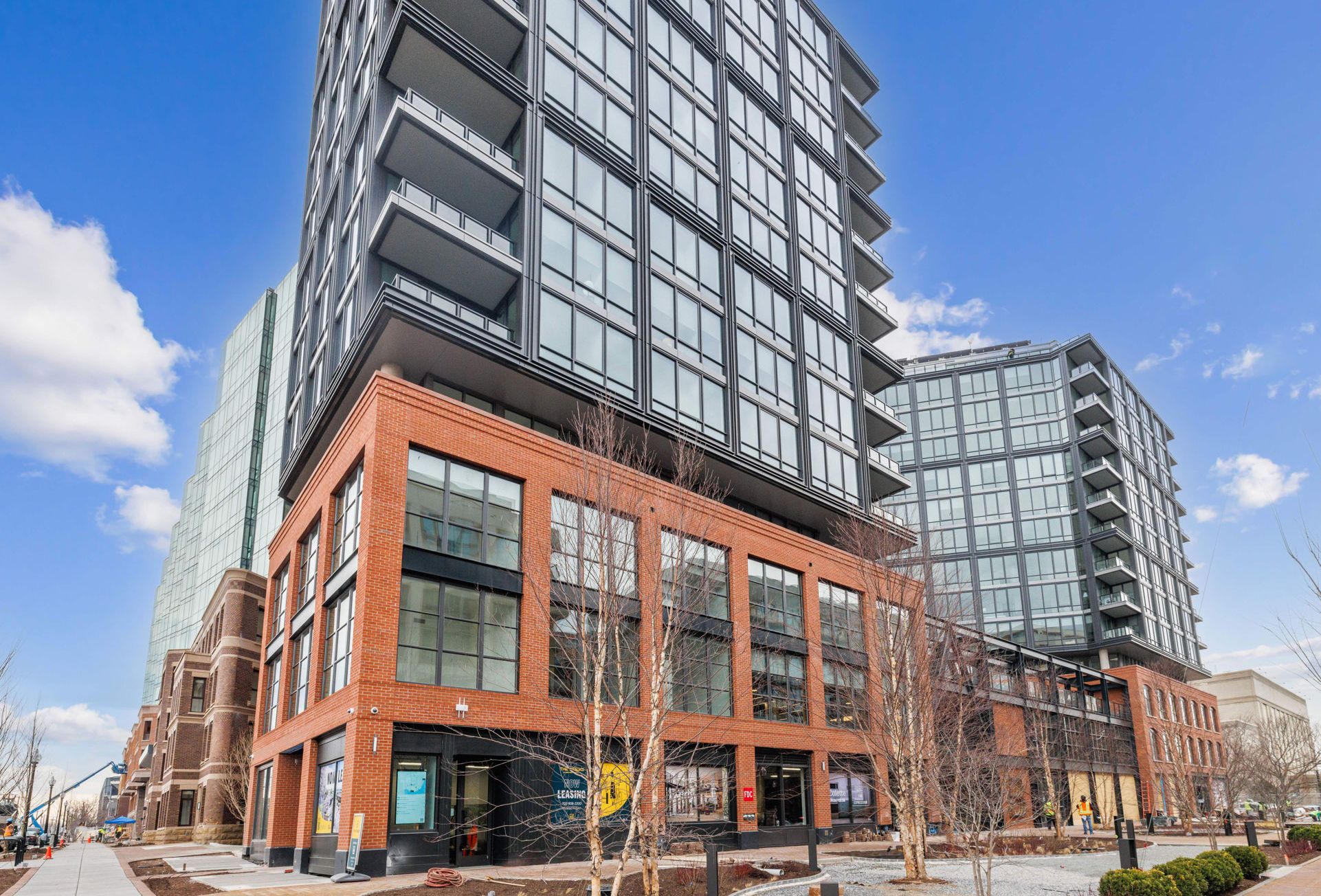 A modern multi-story building with large windows and a brick facade.