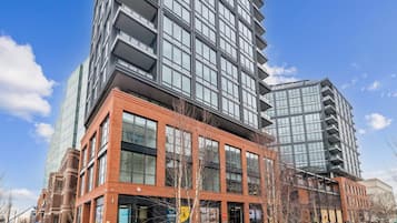 A modern multi-story building with large windows and a brick facade.