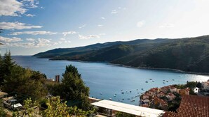 A coastal town with a view of the sea and hills.