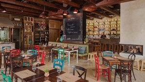 A restaurant interior with wooden tables and chairs, a chalkboard menu, and a bar area. - Mobile home with air conditioning, terrace and pool (Tar/Poreč)