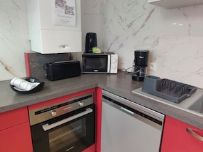 A compact kitchen with a microwave, toaster, coffee maker, and dishwasher. - House for 6 People Near Beauval (Selles-sur-Cher)