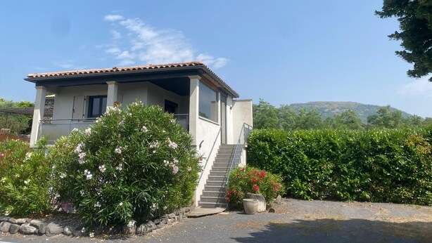 A two-story house with a tiled roof, a balcony, and a staircase leading to the upper floor. - Les Lauriers Roses: Heated pool, unspoilt nature (Saint-Vincent-de-Barrès)