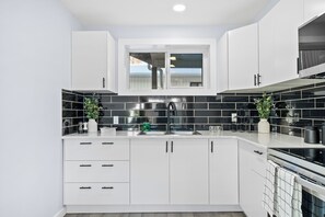 Fridge, dishwasher, coffee/tea maker, cookware/dishes/utensils